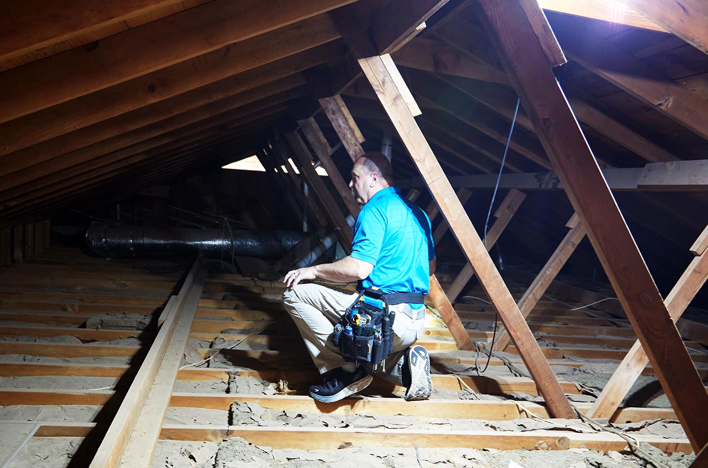 Certified home inspector Craig in the attic of a house