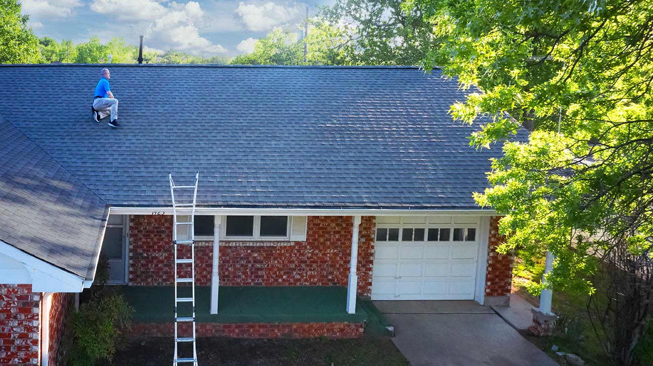 Craig Covington on a roof doing a home inspection 